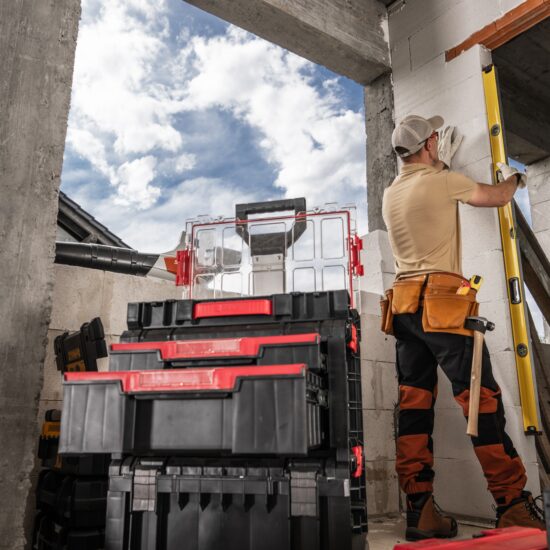 A,Construction,Worker,Uses,A,Level,To,Measure,A,Wall