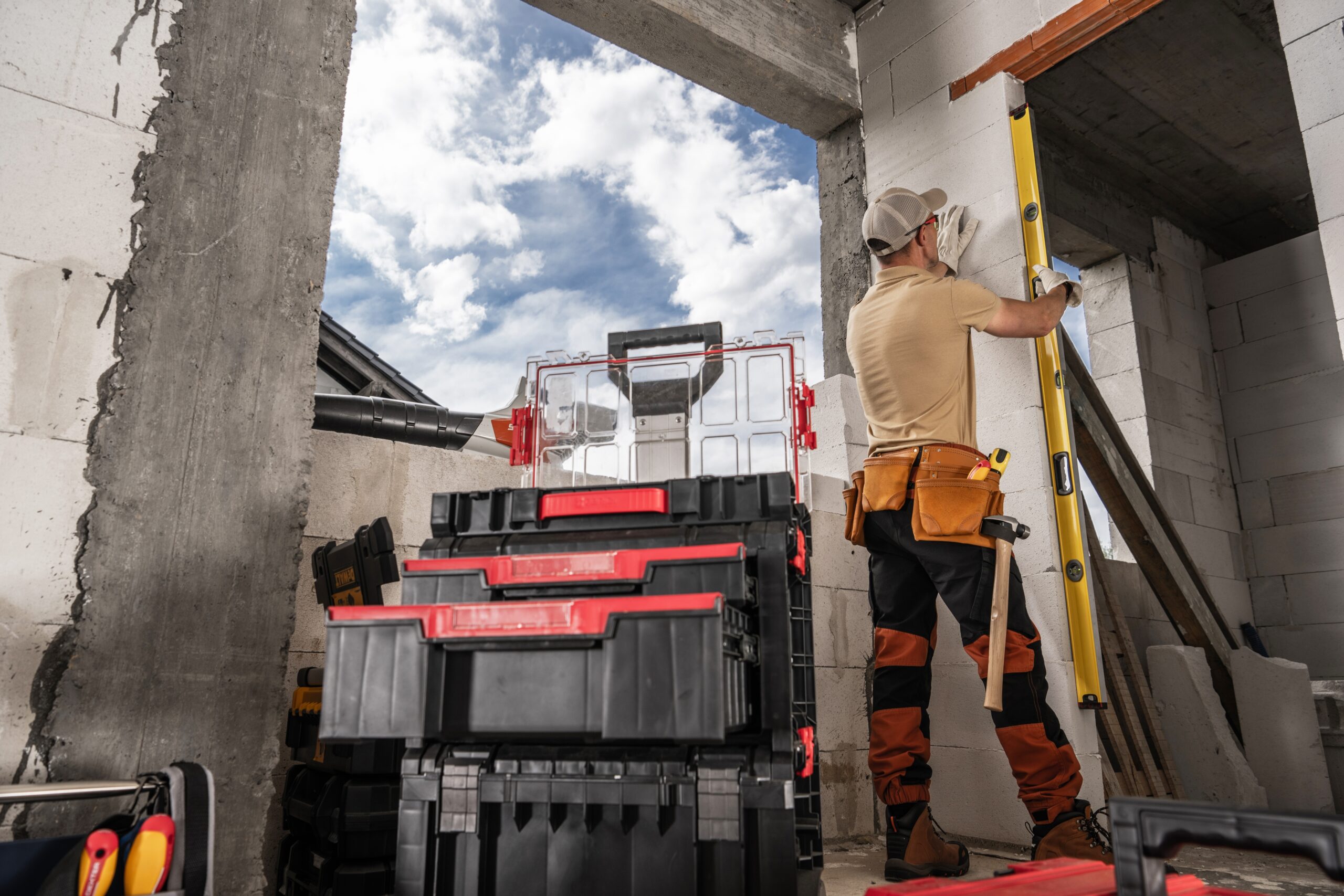 A,Construction,Worker,Uses,A,Level,To,Measure,A,Wall